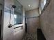 Walk-in shower features decorative tile accents, a built-in bench, and a rainfall shower head at 9464 St Marys Ct, Port Charlotte, FL 33981