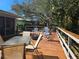 Large outdoor deck with multiple seating areas and a fire pit feature at 4553 Linwood St, Sarasota, FL 34232