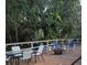 Outdoor deck with a fire pit and overhead string lights, creating a cozy ambiance at 4553 Linwood St, Sarasota, FL 34232