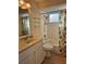 Cozy bathroom features a tub, tiled walls, tropical shower curtain, and updated vanity at 4553 Linwood St, Sarasota, FL 34232