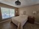 Serene bedroom with neutral tones, two side tables and a large window at 4553 Linwood St, Sarasota, FL 34232