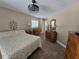 Comfortable bedroom with decorative ceiling fan and warm neutral color palette at 4553 Linwood St, Sarasota, FL 34232