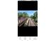 Scenic view of a walking bridge and railway track surrounded by lush green trees at 4553 Linwood St, Sarasota, FL 34232