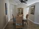 Dining room with a glass table, four cushioned chairs, and a decorative hutch at 4553 Linwood St, Sarasota, FL 34232