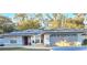 Beautiful single-story home featuring solar panels, a front courtyard and attached two-car garage at 4553 Linwood St, Sarasota, FL 34232