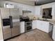 Updated kitchen with stainless steel appliances, white cabinets, and a spacious layout at 4553 Linwood St, Sarasota, FL 34232
