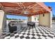 A covered balcony with checkerboard flooring provides seating and overlooks city views for entertaining and relaxation at 1067 Westway Dr, Sarasota, FL 34236