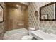 Modern bathroom with tiled shower, glass door, and elegant fixtures at 1067 Westway Dr, Sarasota, FL 34236