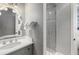 Stylish bathroom featuring gray patterned walls, a glass shower, and modern fixtures at 1067 Westway Dr, Sarasota, FL 34236