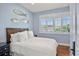 Charming bedroom featuring patterned wallpaper, a comfortable bed, and window with natural light at 1067 Westway Dr, Sarasota, FL 34236