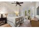 Relaxing bedroom featuring nautically themed wallpaper, a comfortable bed, and French doors to the outside at 1067 Westway Dr, Sarasota, FL 34236