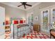 Bedroom with a metal frame bed, bright orange pillows, and a playful patterned rug at 1067 Westway Dr, Sarasota, FL 34236