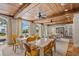 Bright dining area with wood-beamed ceilings, large windows, and poolside views at 1067 Westway Dr, Sarasota, FL 34236