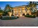 Gorgeous estate featuring a fountain, lush landscaping, and stunning architectural details at 1067 Westway Dr, Sarasota, FL 34236