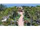 An extravagant home with lush landscaping and a winding walkway through a tropical paradise at 1067 Westway Dr, Sarasota, FL 34236