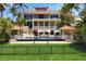 Elegant home with a pool, lush lawn, and multiple outdoor entertaining areas at 1067 Westway Dr, Sarasota, FL 34236