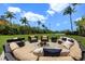 Cozy outdoor fire pit area with comfortable seating and lush tropical surroundings at 1067 Westway Dr, Sarasota, FL 34236