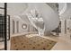 Elegant foyer with a grand spiral staircase, marble flooring, and refined architectural details at 1067 Westway Dr, Sarasota, FL 34236