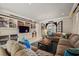 Cozy living room with comfortable sectional sofa, built-in shelving, and views to the outdoors at 1067 Westway Dr, Sarasota, FL 34236