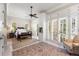 A spacious bedroom is bathed in natural light from large windows and features an elegant ceiling fan at 1067 Westway Dr, Sarasota, FL 34236