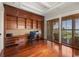 Beautiful home office with hardwood floors, custom built-ins, and sliding glass doors with ocean views at 1067 Westway Dr, Sarasota, FL 34236