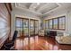 Bright office space with hardwood floors, a sitting area, and sliding glass doors showcasing ocean views at 1067 Westway Dr, Sarasota, FL 34236