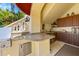 Outdoor kitchen with granite countertops, built-in grill, and ample cabinet space at 1067 Westway Dr, Sarasota, FL 34236