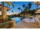 Tranquil pool area with comfortable lounge chairs, lush landscaping, and a charming gazebo creating a relaxing outdoor oasis at 1067 Westway Dr, Sarasota, FL 34236