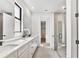 Elegant bathroom featuring double vanity, a glass enclosed shower, and modern fixtures at 12719 Sunbridge Dr, Venice, FL 34293