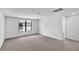 Bright bedroom with plush carpeting, a large window, and neutral color scheme at 12719 Sunbridge Dr, Venice, FL 34293