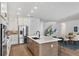 Open kitchen with a large center island, stainless steel appliances, and modern white cabinetry at 12719 Sunbridge Dr, Venice, FL 34293