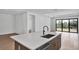 Modern kitchen island with quartz countertop, stainless steel sink and appliances, and hardwood flooring creating a clean design at 12719 Sunbridge Dr, Venice, FL 34293
