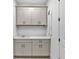 Well-equipped laundry room with ample cabinet space, sink, and quartz countertop at 12719 Sunbridge Dr, Venice, FL 34293