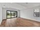 Bright living room with hardwood floors and sliding glass doors leading to an outdoor patio area, bringing the outside in at 12719 Sunbridge Dr, Venice, FL 34293