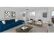 Cozy Gathering room featuring a comfortable blue sofa, stylish decor, and plenty of natural light at 12719 Sunbridge Dr, Venice, FL 34293