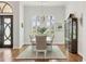 Bright dining room with chandelier, hardwood floors, and arched windows with shutter blinds at 16009 Clearlake Ave, Lakewood Ranch, FL 34202