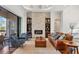 Bright living room with fireplace, built-in shelving, and sliding glass doors leading to outdoor living space at 16009 Clearlake Ave, Lakewood Ranch, FL 34202