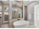 Bright bathroom with large soaking tub, open shower concept, and modern finishes at 16009 Clearlake Ave, Lakewood Ranch, FL 34202