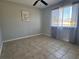 Bedroom features a ceiling fan and a window with sheer curtains at 18053 Ohara Dr, Port Charlotte, FL 33948