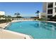 Resort-style pool with lounge chairs and ocean views, perfect for relaxation and enjoying the coastal scenery at 2020 Harbourside Dr # 432, Longboat Key, FL 34228