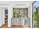 Stylish bar area with stone backsplash, wine fridge, and ample storage, perfect for entertaining at 2149 Hyde Park St, Sarasota, FL 34239