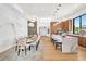 Open-concept dining area with modern lighting, stylish seating for ten, and views into the gourmet kitchen at 2149 Hyde Park St, Sarasota, FL 34239