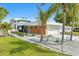 Modern home with sleek design, showcasing a meticulously landscaped front yard and contemporary architectural features at 2149 Hyde Park St, Sarasota, FL 34239