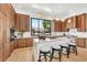 Elegant kitchen with wood cabinets, marble countertops, stylish island seating, and pendant lighting at 2149 Hyde Park St, Sarasota, FL 34239
