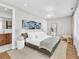Bright bedroom with a large bed, unique lighting, and a decorative mirror at 2149 Hyde Park St, Sarasota, FL 34239