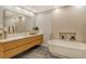 Bathroom with sleek fixtures, a soaking tub, and a large seamless glass mirror at 435 L Ambiance Dr # L807, Longboat Key, FL 34228