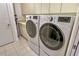 Bright laundry room featuring full-sized, front-load washer and dryer, and built-in storage at 435 L Ambiance Dr # L807, Longboat Key, FL 34228
