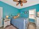 A blue bedroom with a ceiling fan and two windows bringing in lots of natural light at 4802 51St W St # 1811, Bradenton, FL 34210