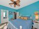 Bedroom with blue walls, white trim, and gray wood floors at 4802 51St W St # 1811, Bradenton, FL 34210