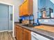 Kitchen sink with wood cabinets, dark countertops, wood floors, and stainless steel appliances at 4802 51St W St # 1811, Bradenton, FL 34210